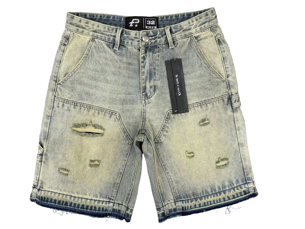 Distressed denim shorts with a brand tag on a gray background