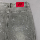 Gray jeans with rhinestone embellishments on a gray background